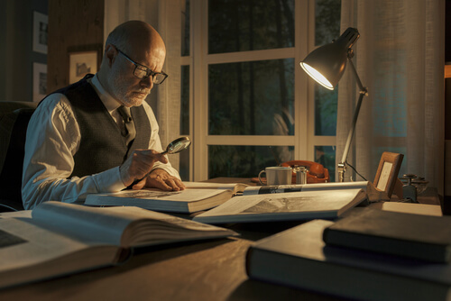 Scientists with a book and a magnifying glass oldest language in the world skrivanek