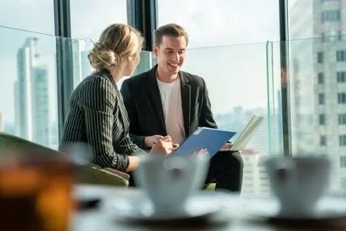 Businessman and businesswoman discuss documents post editing skirvanek