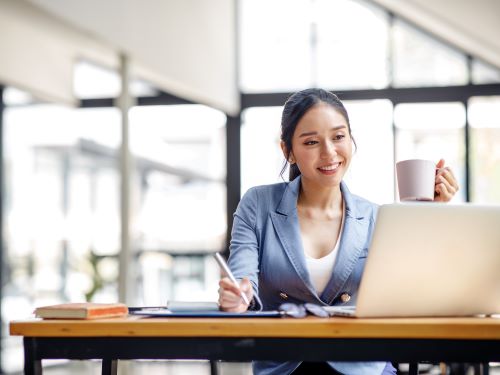 Asiatische Geschaftsfrau mit Laptop und arbeitet im Buro mit Taschenrechner steuerbescheid ubersetzen lassen ubersetzungsburo berlin